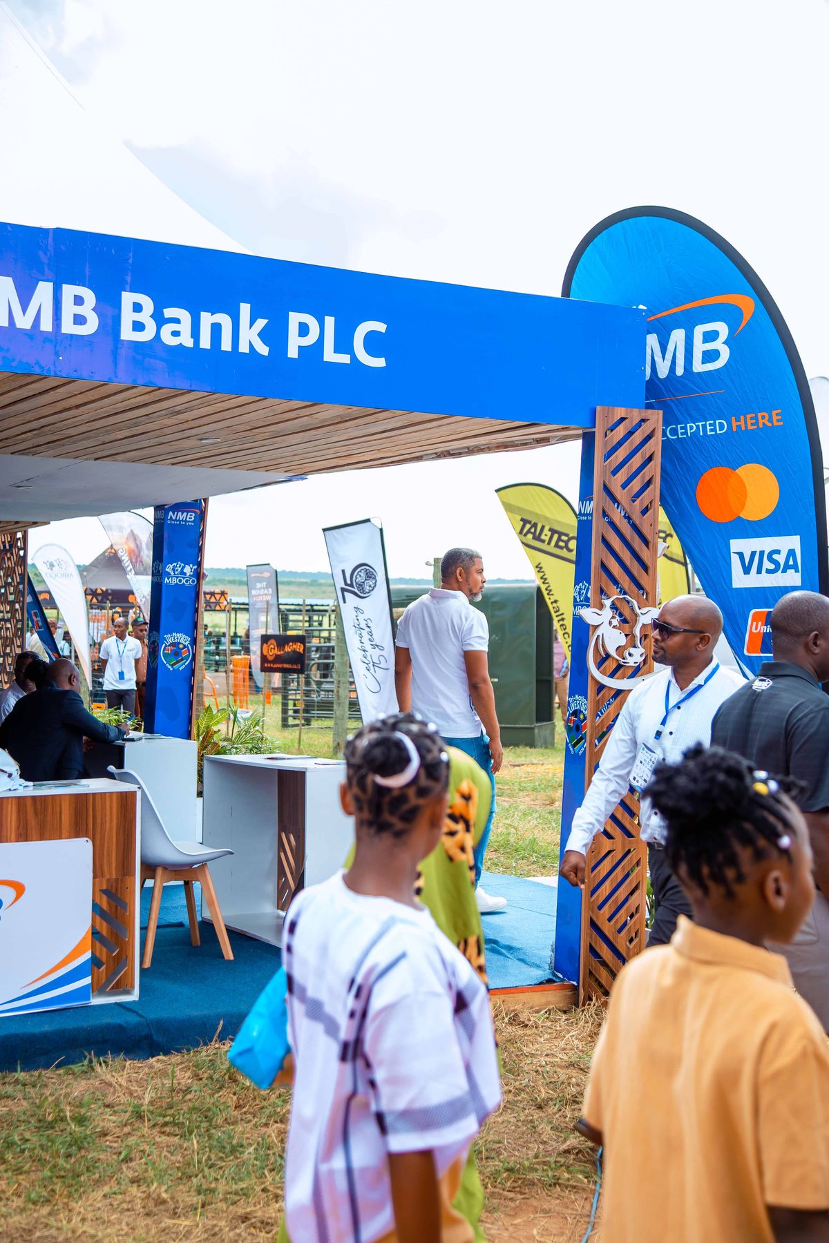 Families and visitors at the NMB Bank tent entrance, Ubena Zomozi livestock event