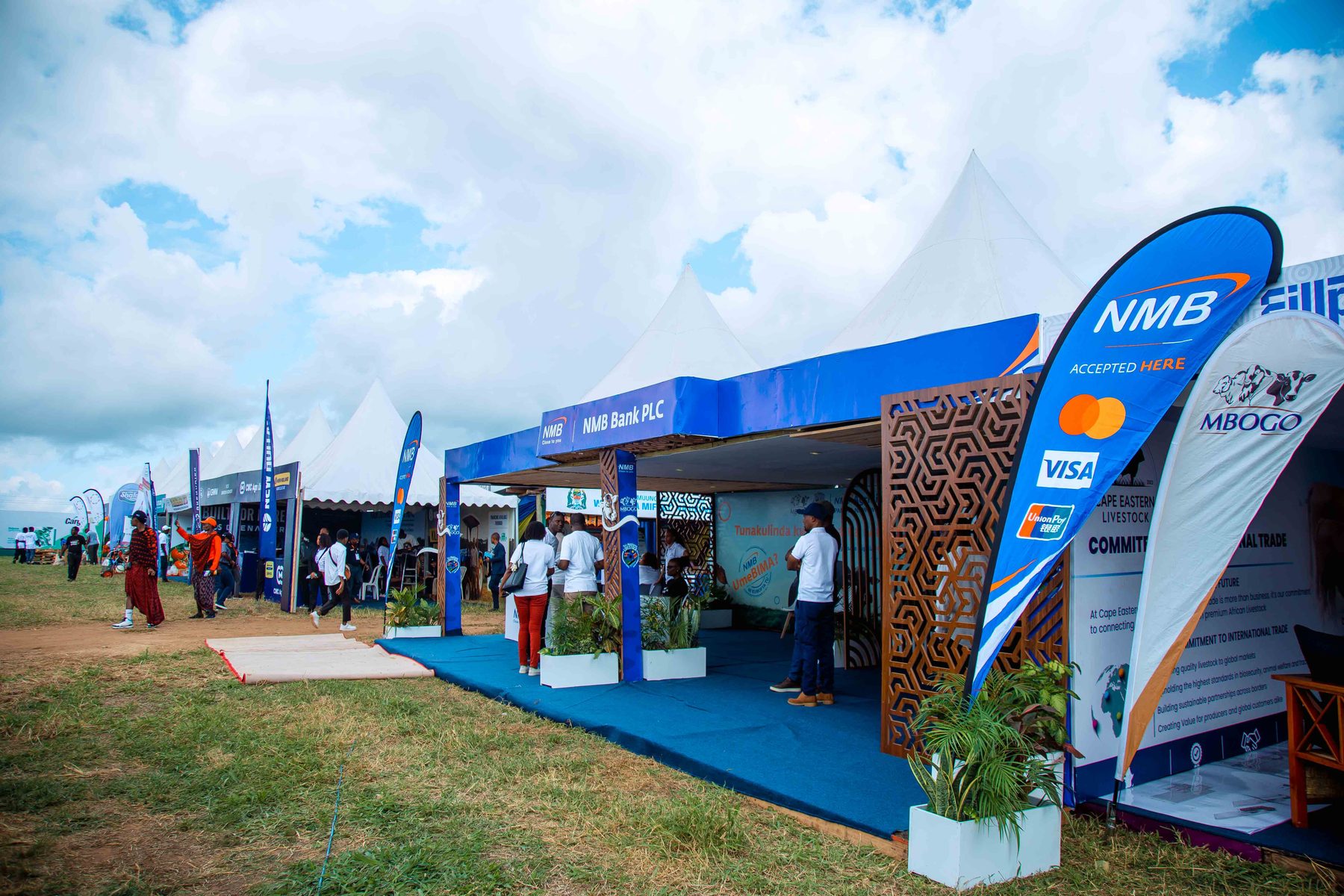 Row of exhibitor tents including the NMB Bank booth at the Ubena Zomozi livestock exhibition