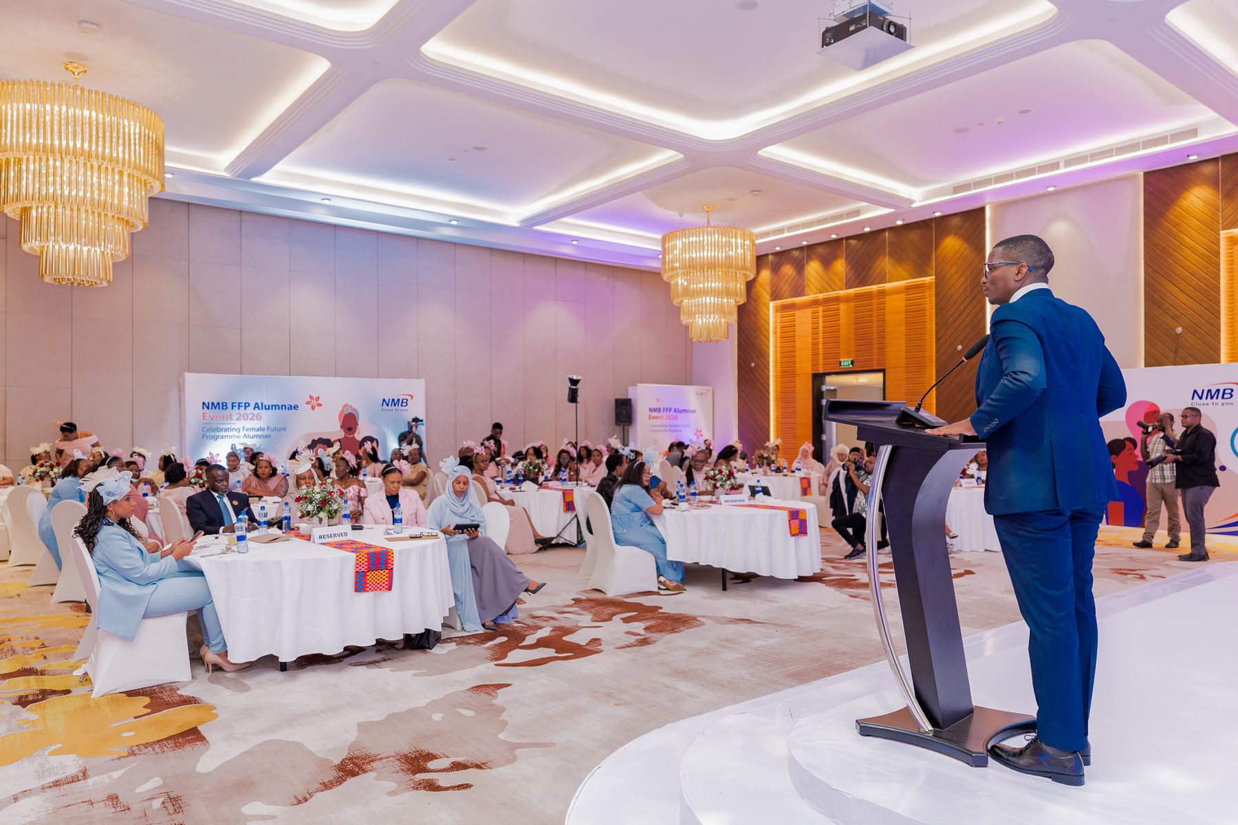 Full ballroom at the NMB FFP Alumnae Event 2026, speaker addressing 300 guests at Serena Hotel