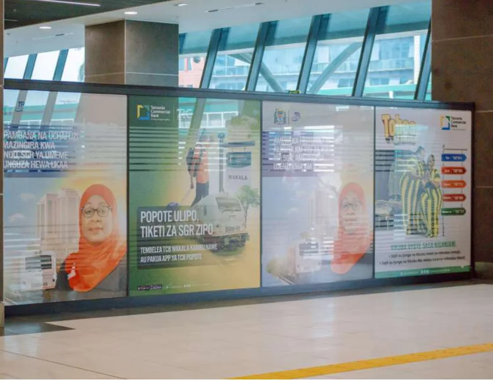 Row of branded corridor panels inside an SGR station