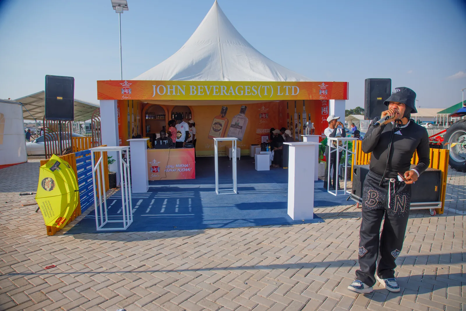 MC hosting the crowd outside the John Beverages (JBL) exhibition tent at Nane Nane Grounds, Dodoma
