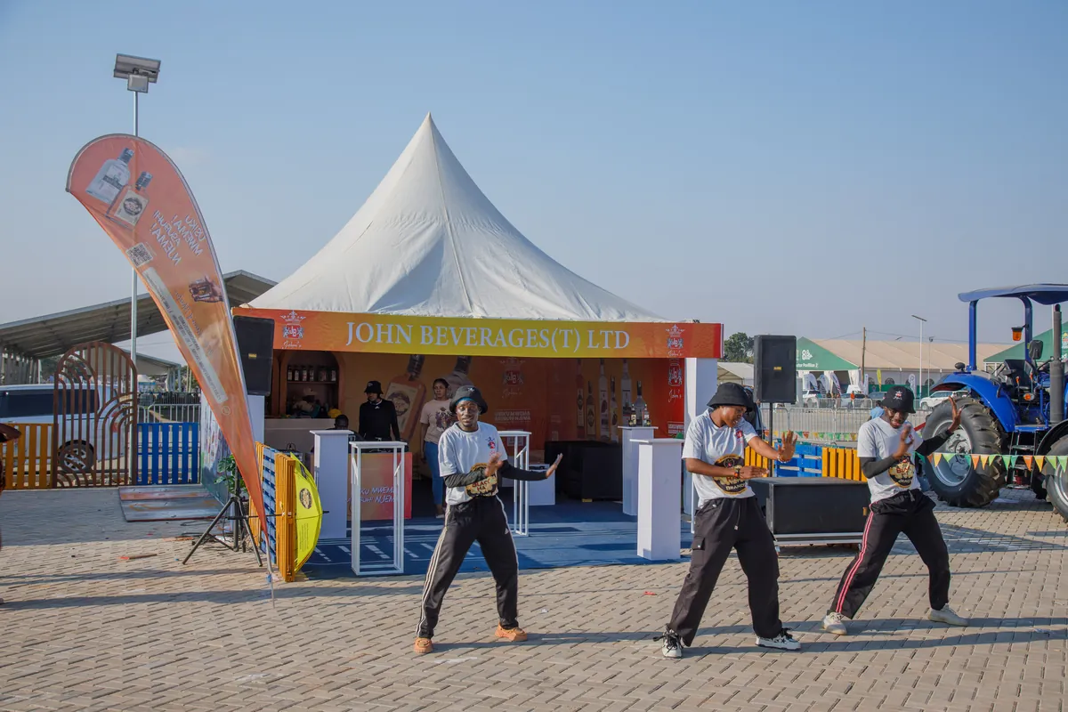 Dance crew performing in front of the John Beverages (JBL) stand to draw crowds at Nane Nane Grounds, Dodoma